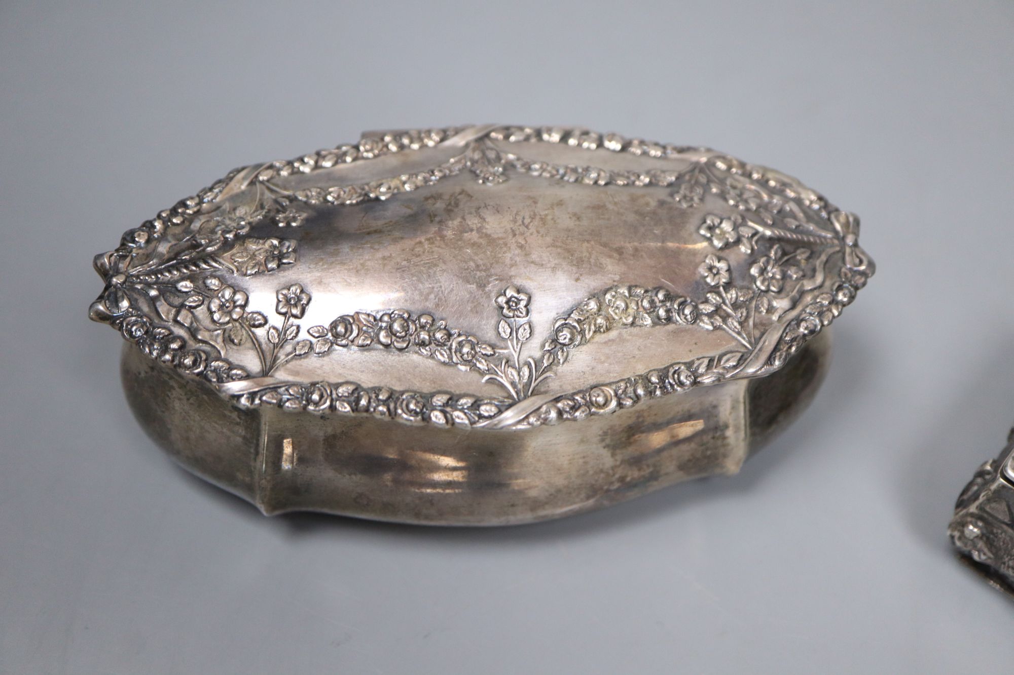A Victorian silver rectangular box embossed with medieval hunting scenes, 15.3cm and two other embossed silver trinket boxes,